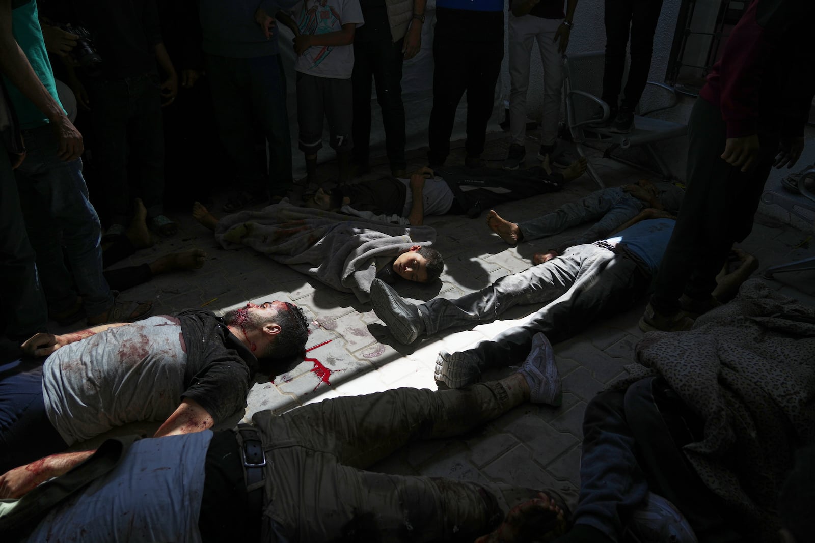 Bodies of some of the victims of an Israeli army strike on a restaurant, which killed at least 29 people, lie on the floor after the were taken from the scene to the Shifa hospital in Gaza City, Wednesday, May 7, 2025.(AP Photo/Jehad Alshrafi)