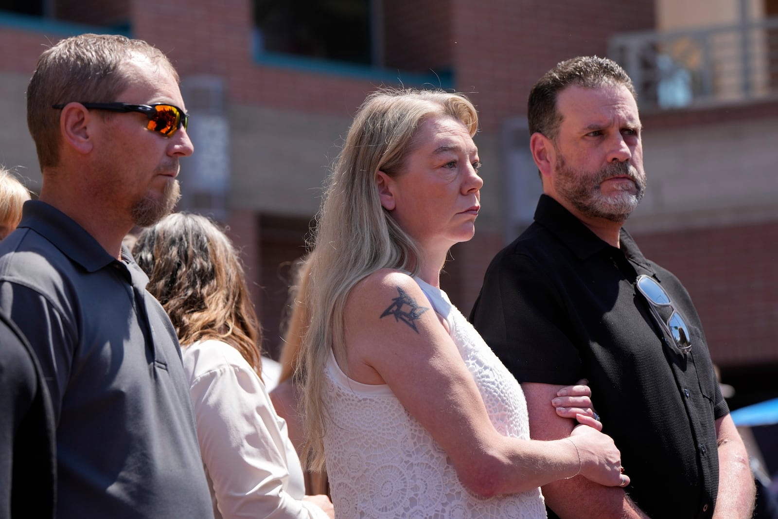 Karen and Scott Laramie, the mother and stepfather of Madison Mogen, listen as their attorney Leander James makes a statement to members of the media outside the Ada County Courthouse on Wednesday, July 2, 2025, in Boise, Idaho. (AP Photo/Jenny Kane)