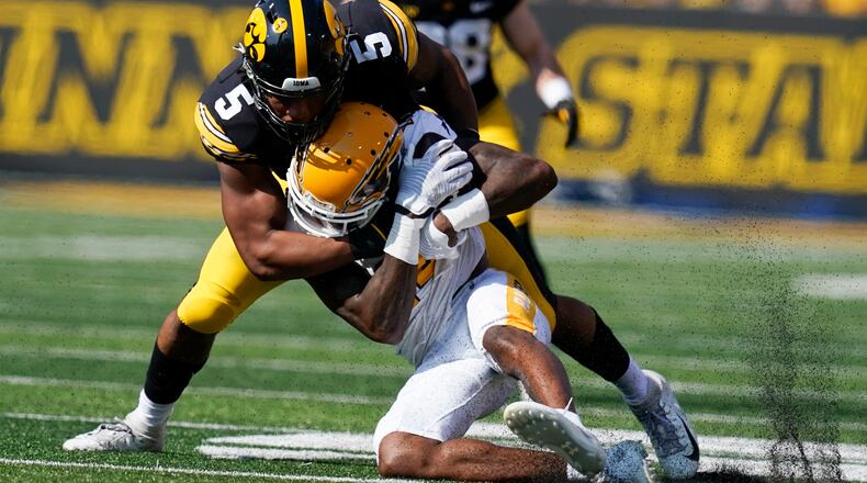 Kent State wide receiver Dante Cephas (14) is tackled by Iowa linebacker Jestin Jacobs (5) after catching a pass during the first half of an NCAA college football game, Saturday, Sept. 18, 2021, in Iowa City, Iowa. (AP Photo/Charlie Neibergall)