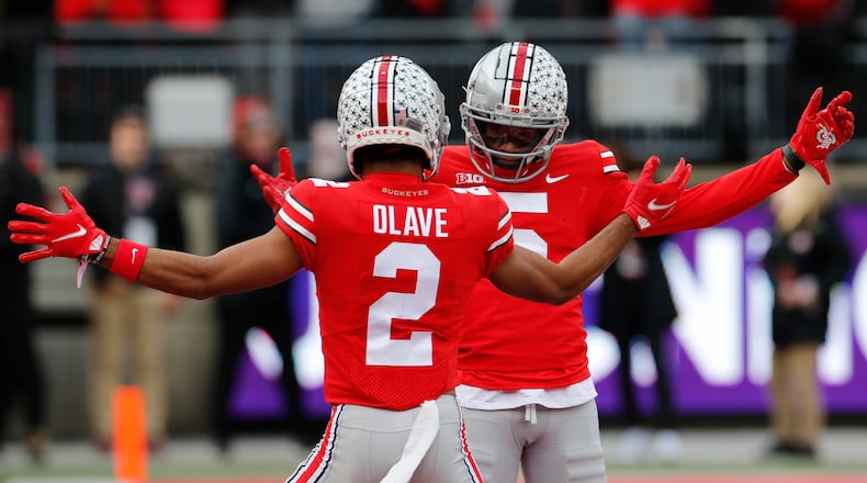 Ohio State receiver Garrett Wilson, right, celebrates his touchdown against Michigan State with teammate Chris Olave during the first half of an NCAA college football game Saturday, Nov. 20, 2021, in Columbus, Ohio. (AP Photo/Jay LaPrete)