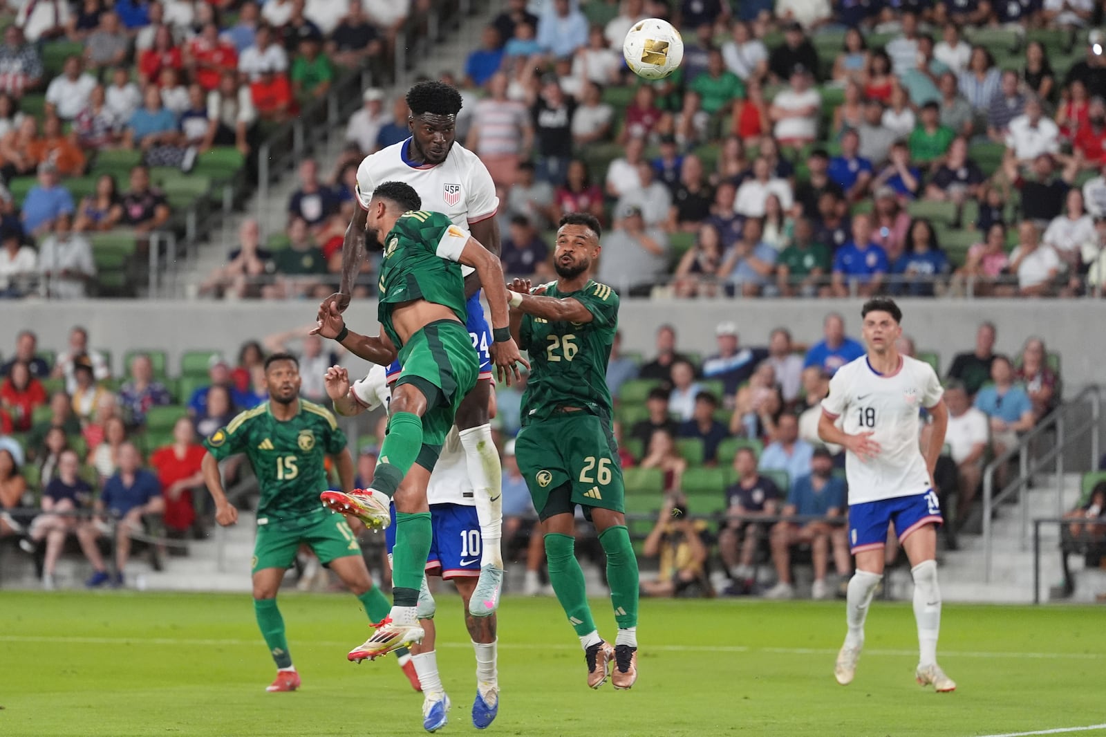 United States' Patrick Agyemang (24) leaps between Saudi Arabia's Abdulelah Alamri (4) and Ali Majrashi (26) and heads the ball towards the goal during a CONCACAF Gold Cup soccer match, Thursday, June 19, 2025, in Austin, Texas. (AP Photo/Eric Gay)