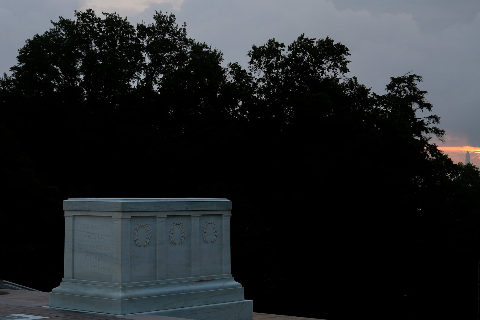 The Washington Monument is visible behind the Tomb of the Unknown Soldier at sunrise, Thursday, May 15, 2025, Arlington National Cemetery in Arlington, Va. (AP Photo/Julia Demaree Nikhinson)