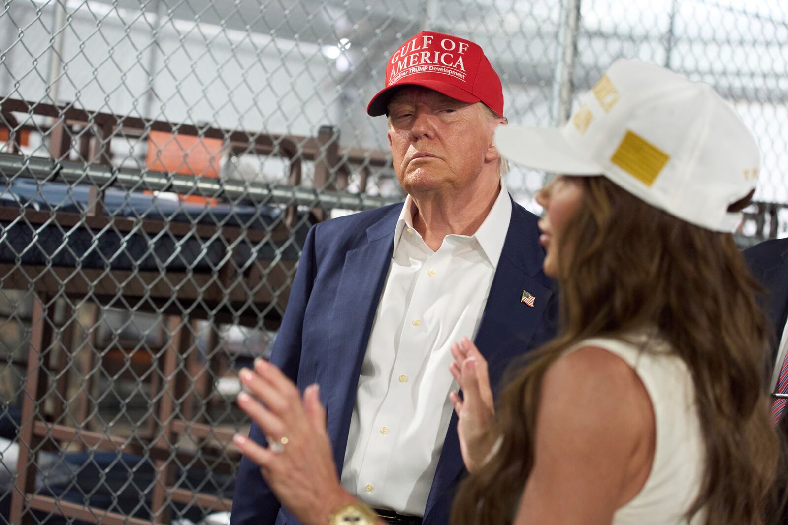 President Donald Trump listens as Homeland Security Secretary Kristi Noem speaks during a tour of "Alligator Alcatraz," a new migrant detention facility at Dade-Collier Training and Transition facility, Tuesday, July 1, 2025, in Ochopee, Fla. (AP Photo/Evan Vucci)