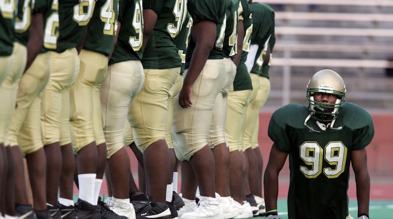 Dayton’s Colonel White’s Bobby Martin moves behind teammates as they line up on the field prior to a game vs. Dunbar in 2005. Despite being born without legs, Martin played defensive line, keeping up with and taking down two-legged players twice his size. Jim Witmer/DDN FILE