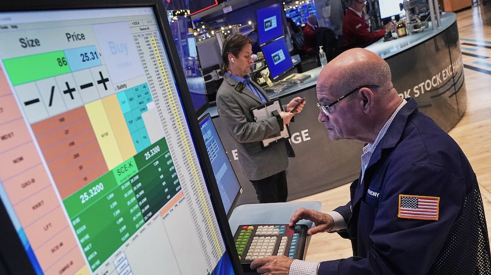 Trader Anthony Confusione works on the floor of the New York Stock Exchange, Thursday, Dec. 11, 2025. (AP Photo/Richard Drew)