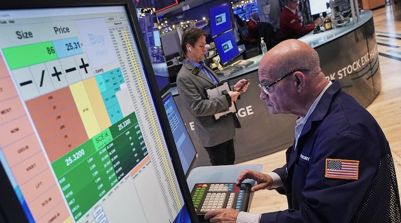 Trader Anthony Confusione works on the floor of the New York Stock Exchange, Thursday, Dec. 11, 2025. (AP Photo/Richard Drew)