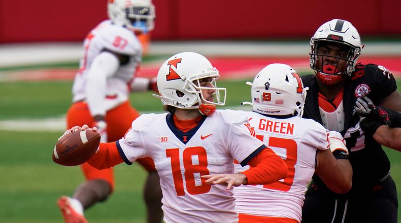 Illinois quarterback Brandon Peters (18) throws behind the block from offensive lineman Kendrick Green (53) during the first half of an NCAA college football game against Nebraska in Lincoln, Neb., Saturday, Nov. 21, 2020. (AP Photo/Nati Harnik)