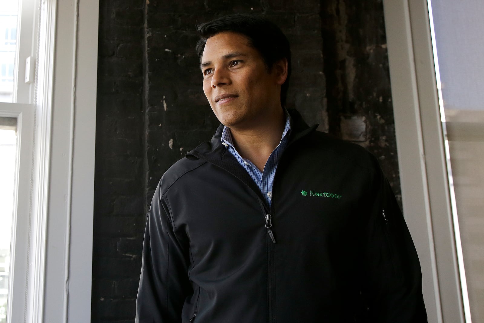FILE - Nextdoor CEO Nirav Tolia poses for photos at his office in San Francisco on May 11, 2016. (AP Photo/Jeff Chiu, File)