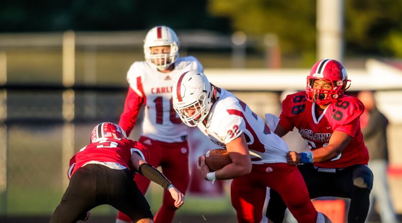 Carlisle running back Jayden Sweeney carries the ball defended by Madison lineman Tyler McCracken (66) and Konnor Maloney during their football game Friday, Sept. 18, 2020 at Madison High School in Madison Township. Madison won 30-20. NICK GRAHAM / STAFF