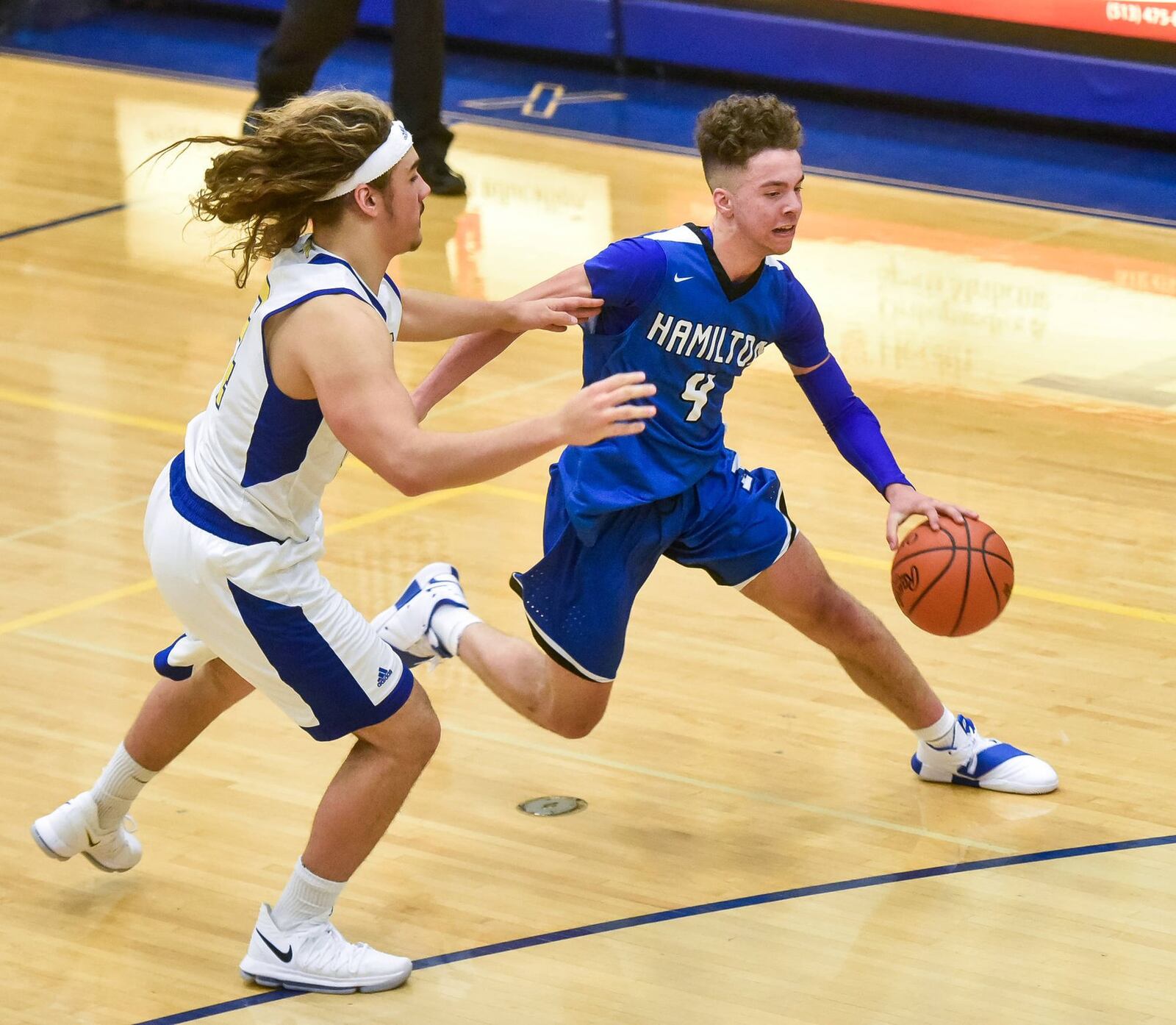 Hamilton’s Jaylen Robinson attempts to dribble past Northwest’s Diego Neri during Friday night’s game at Northwest. HHS won 58-52. NICK GRAHAM/STAFF