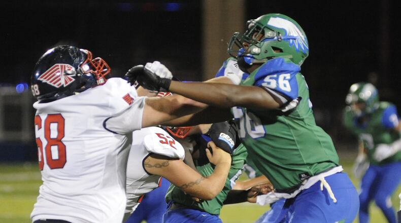 Caden Clark (left) of Piqua matches up with CJ’s Shane Cokes. CJ defeated visiting Piqua 42-22 in a Week 1 high school football game on Friday, Aug. 24, 2018. MARC PENDLETON / STAFF