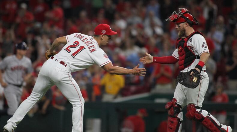 Reds reliever Michael Lorenzen, left, and catcher Tucker Barnhart celebrate after the final out of a victory against the Astros on Tuesday, June 18, 2019, at Great American Ball Park in Cincinnati. David Jablonski/Staff