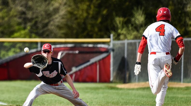 Carlisle’s Caleb Stewart tags stretches to get Madison’s Jake Edwards out at first base during their game April 26, 2018, at Madison. The host Mohawks won 3-1. NICK GRAHAM/STAFF