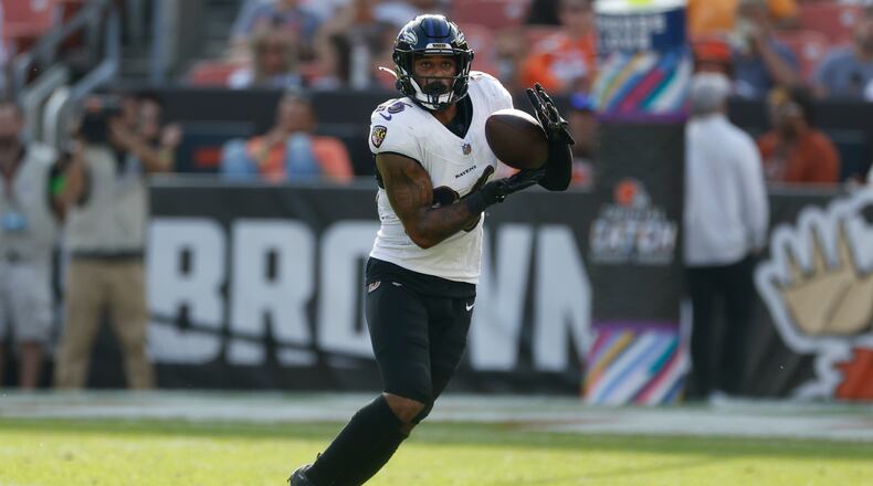 Baltimore Ravens safety Geno Stone (26) intercepts a pass during the second half of an NFL football game against the Cleveland Browns, Sunday, Oct. 1, 2023, in Cleveland. (AP Photo/Ron Schwane)
