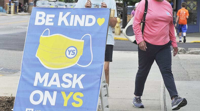 Jeannine Neubauer, left, and Meg Huey, walked around Yellow Springs wearing masks Thursday. The Village passed a resolution to make it a requirement to wear a mask and properly social distance while in the “business district” of Yellow Springs. MARSHALL GORBYSTAFF