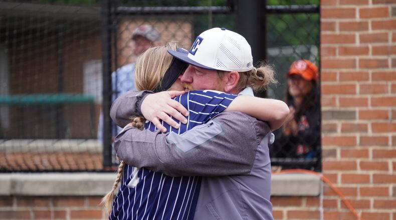 Edgewood coach Wayne Henson embraces his daughter Evelyn Henson after the Cougars fell to Kings in a Division II district final on Friday at Indian Hill. CHRIS VOGT / CONTRIBUTED
