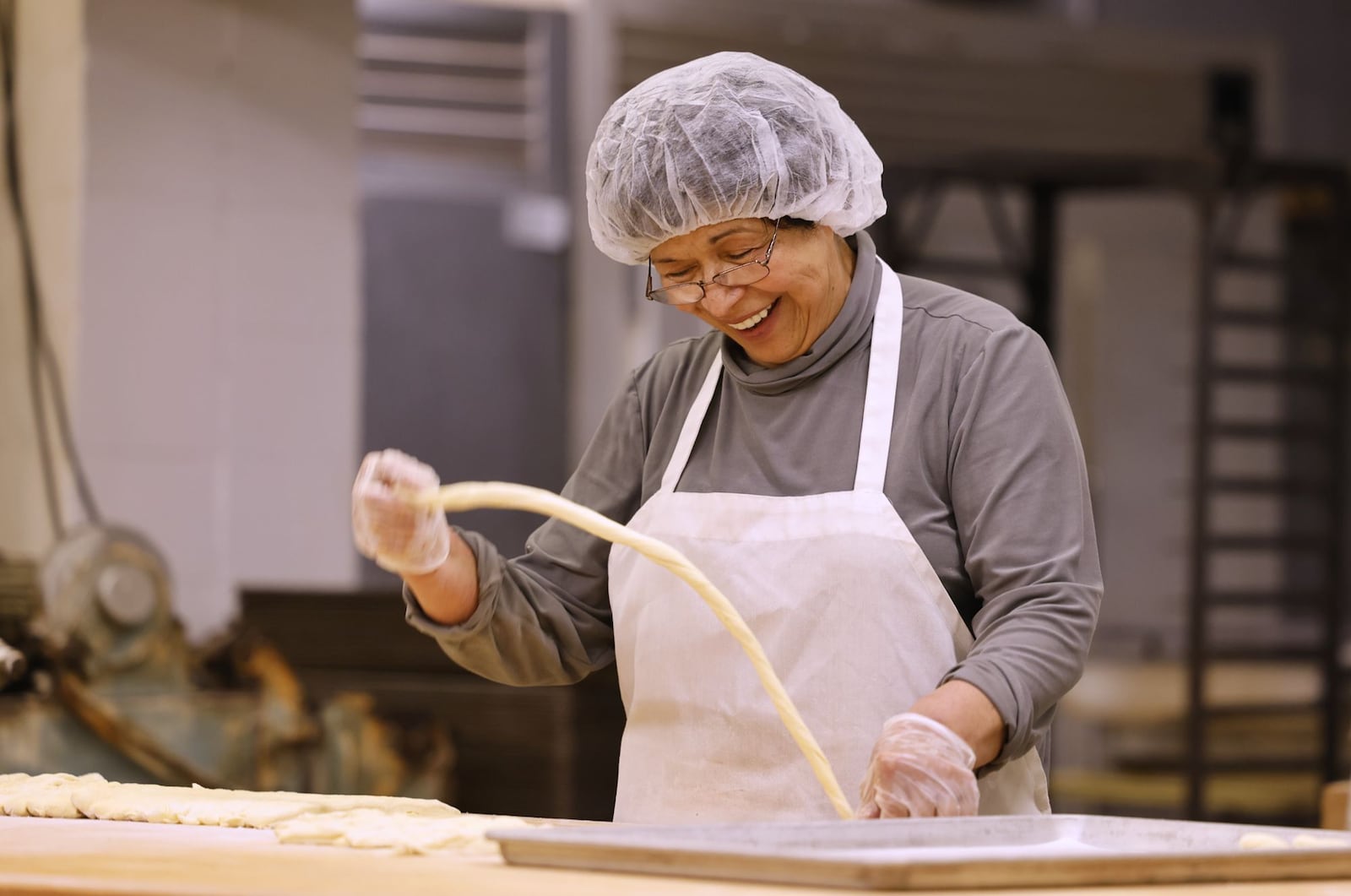 Vera Slamka smiles as she does what she loves in the kitchen at Central Pastry Tuesday, Aug. 13, 2024 on Central Avenue in Middletown. Vera and her husband, John, are celebrating owning Central Pastry for 40 years. NICK GRAHAM/STAFF
