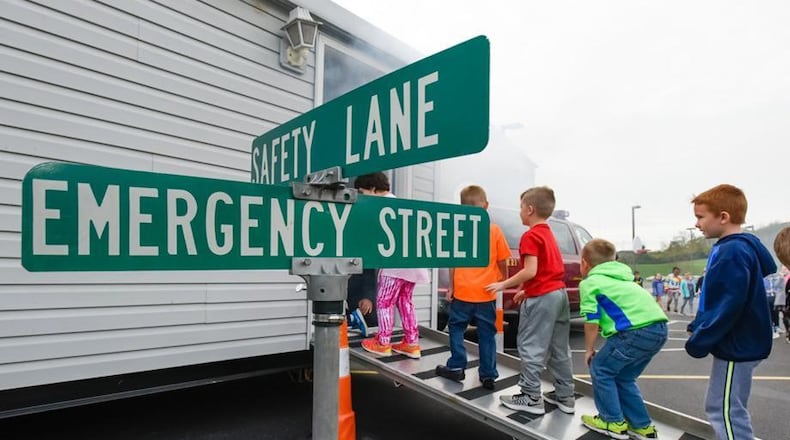 Hamilton firefighters give a fire safety presentation to students at Brookwood Elementary in 2016. NICK GRAHAM/STAFF