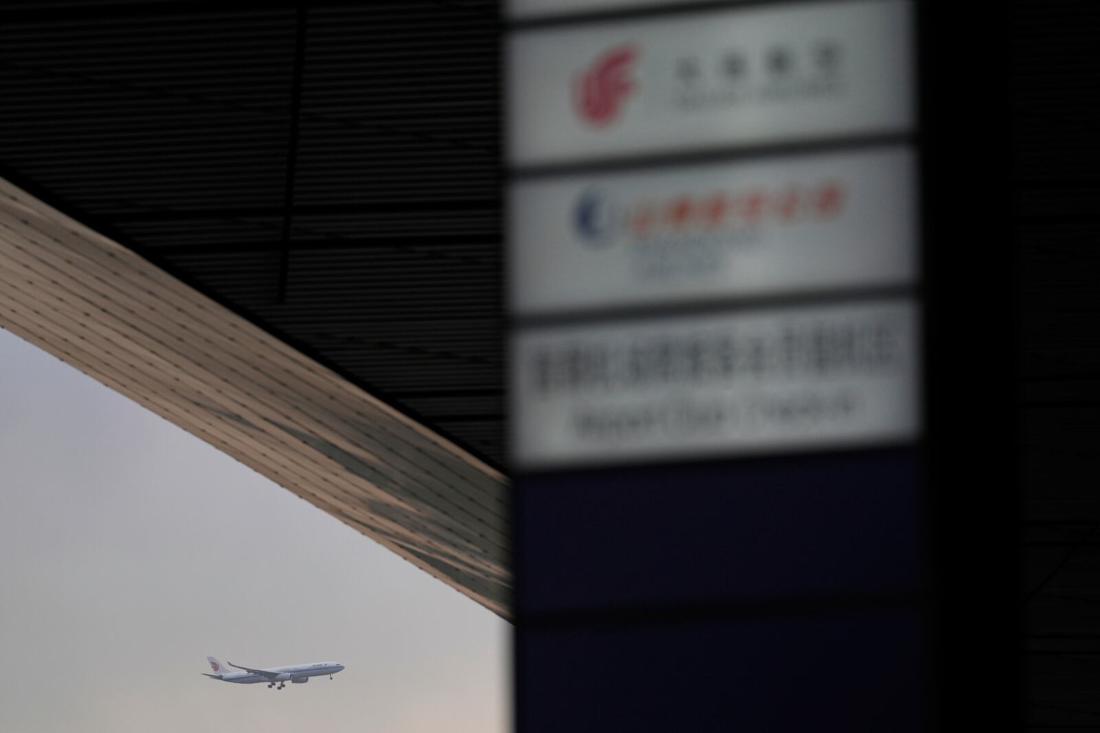An Air China passenger jet prepares to land at the Capital International Airport Terminal 3 as gale wind alerts cancelled flights in Beijing, China, Saturday, April 12, 2025. (AP Photo/Ng Han Guan)