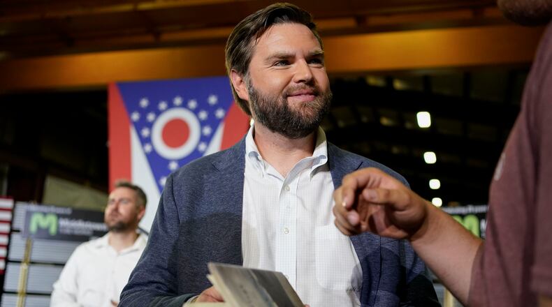 FILE - J.D. Vance, the venture capitalist and author of "Hillbilly Elegy," holds his book as he speaks with supporters after a rally on July 1, 2021, in Middletown, Ohio, where he announced he is joining the crowded Republican race for the Ohio U.S. Senate seat. Sen. Vance, R-Ohio, sharply criticized Donald Trump during the 2016 election cycle, before changing course and embracing the former president. Vance is now one of Trump's fiercest allies and defenders and among those short-listed to be Trump's vice presidential pick. (AP Photo/Jeff Dean, File)