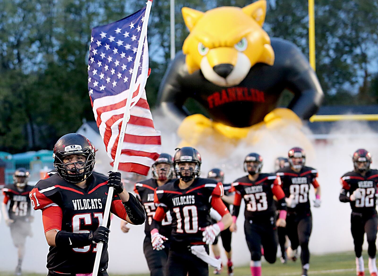 Austin Woods and the Franklin Wildcats run onto the field before their game against the Oakwood Lumberjacks at Atrium Stadium in Franklin on Oct. 21. CONTRIBUTED PHOTO BY E.L. HUBBARD