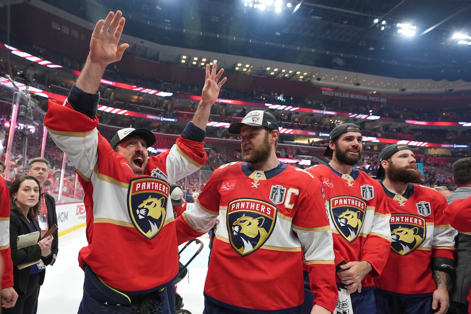 Florida Panthers center Brad Marchand and captain Aleksander Barkov celebrate after defeating the Edmonton Oilers in Game 6 of the NHL hockey Stanley Cup Final Tuesday, June 17, 2025, in Sunrise, Fla. (AP Photo/Lynne Sladky)