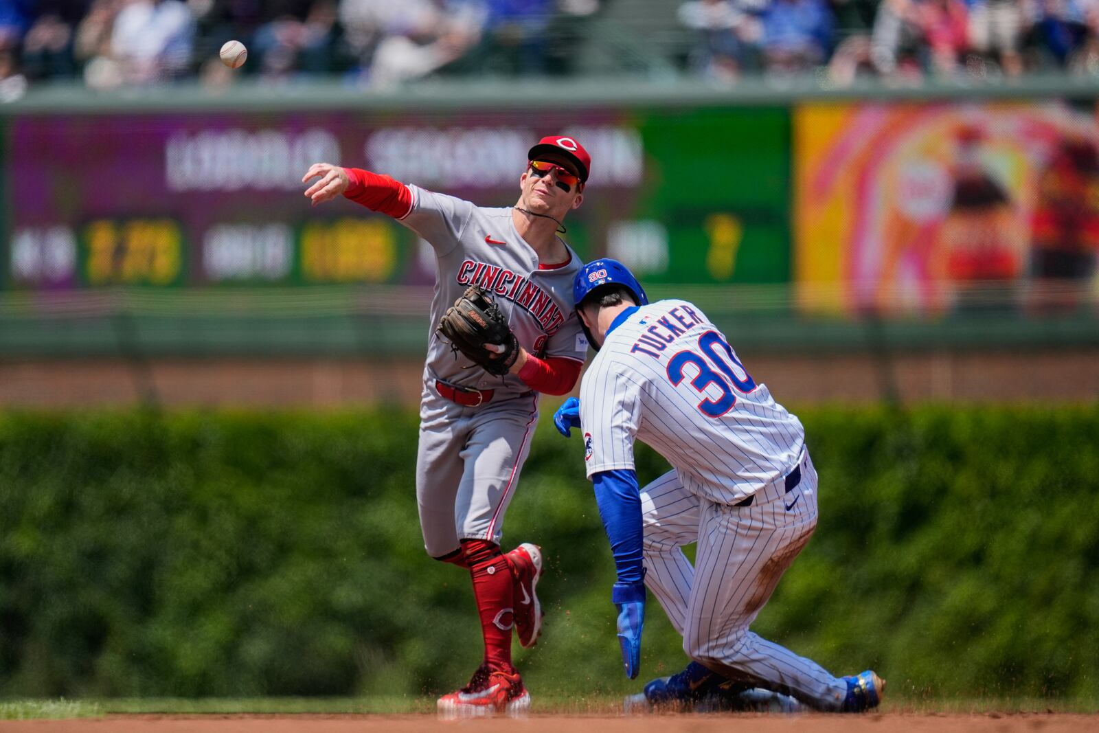 Cincinnati Reds second baseman Matt McLain (9) forces out Chicago Cubs' Kyle Tucker (30) and throws to first for a double play during the first inning of a baseball game Saturday, May 31, 2025, in Chicago. (AP Photo/Erin Hooley)