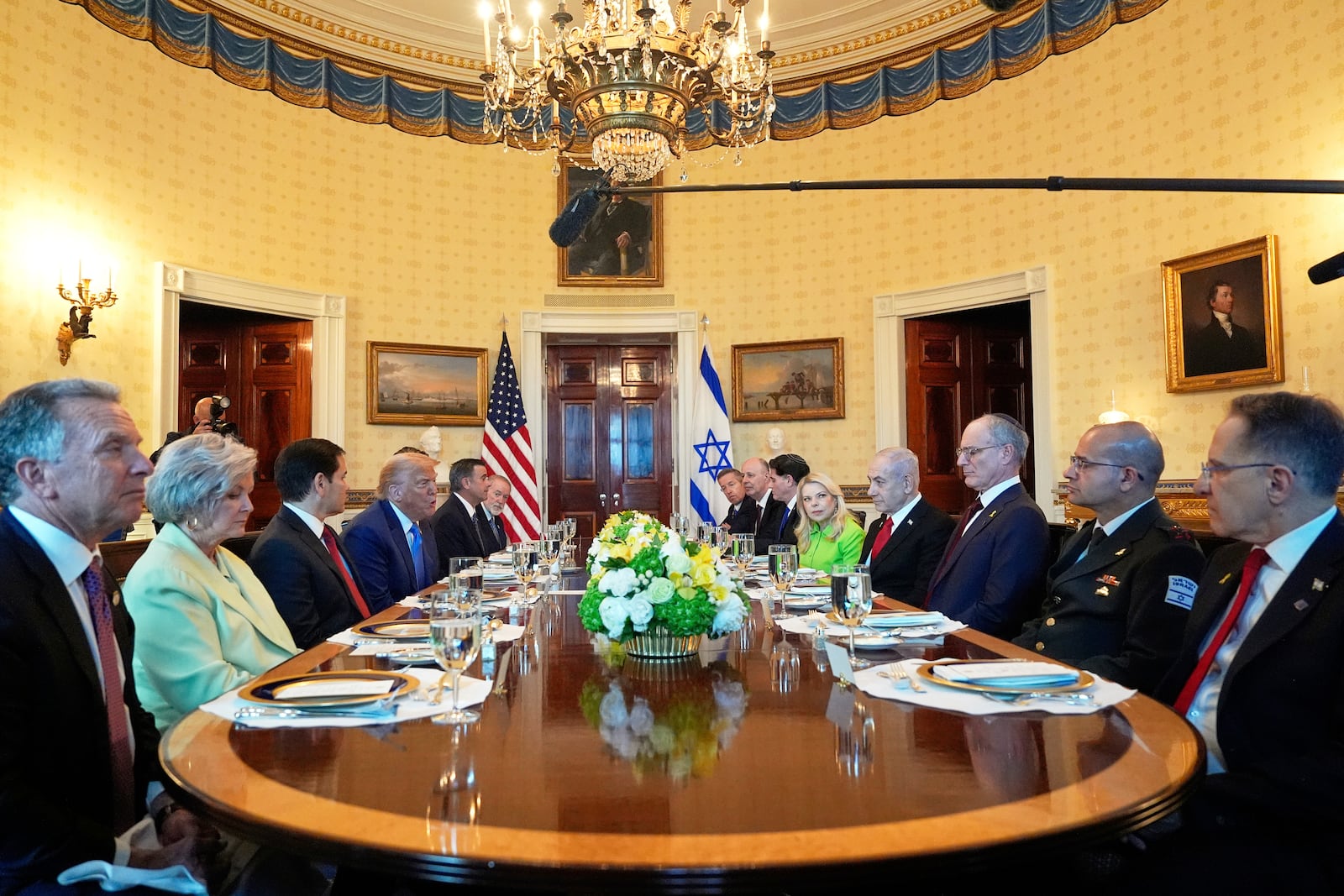 President Donald Trump, fourth from left, meets with Israel's Prime Minister Benjamin Netanyahu, fourth from right, as White House special envoy Steve Witkoff, from left, White House Chief of Staff Susie Wiles, Secretary of State Marco Rubio, Defense Secretary Pete Hegseth, obstructed, CIA Director John Ratcliffe and U.S. Ambassador to Israel Mike Huckabee listen in the Blue Room of the White House, Monday, July 7, 2025, in Washington. (AP Photo/Alex Brandon)