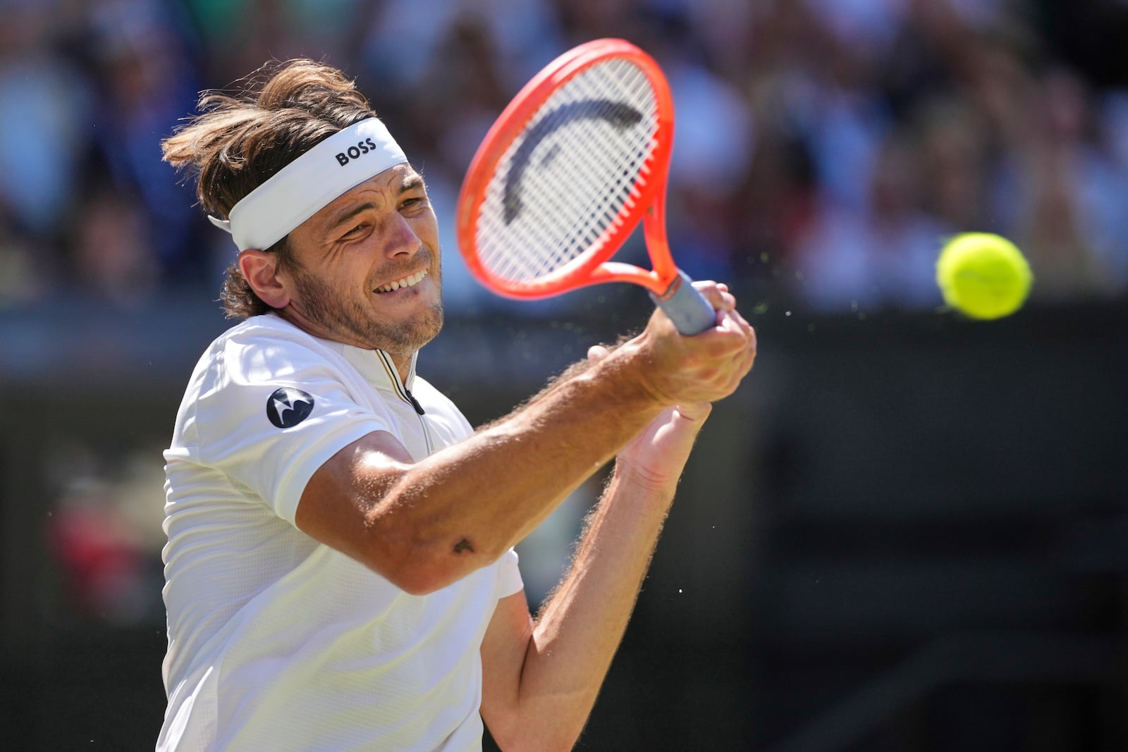 Taylor Fritz of the U.S. returns to Spain's Carlos Alcaraz in a men's singles semifinal at the Wimbledon Tennis Championships in London, Friday, July 11, 2025. (AP Photo/Kin Cheung)