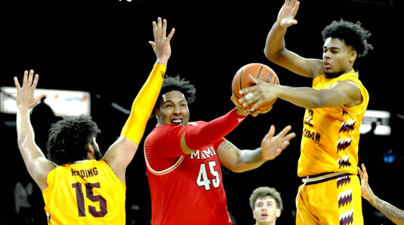 Miami's Anderson Mirambeaux, 45, scores a basket against Central Michigan's Markus Harding, 15 and Nicholas Pavrette, 22, during the first half of a Mid American Conference game at Millett Hall on Saturday, Feb. 11, 2023. DAVID A. MOODIE/CONTRIBUTING PHOTOGRAPHER