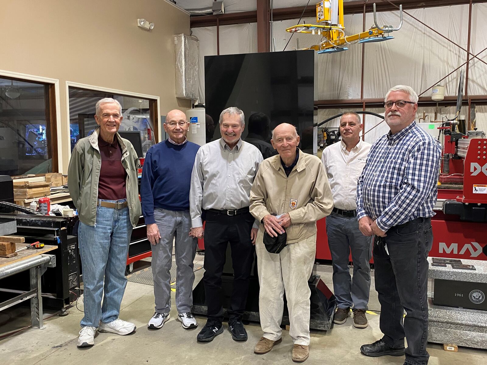 There will be five monolith slabs of granite that will be part of the 67-foot-diameter Fairfield Twp. Veterans Memorial at Heroes Park. Each monolith weights about 6,800 pounds and will be etched to represent the U.S. Military branches on one side and servicemen and women, donors and MIA/POWs. Pictured are memorial committee members, from left, George Byrans, Jack Burns, Fred Valerius, Barney Landry, Granite Imaging and Design owner Jim Smith and Fairfield Twp. Trustee Joe McAbee. MICHAEL D. PITMAN