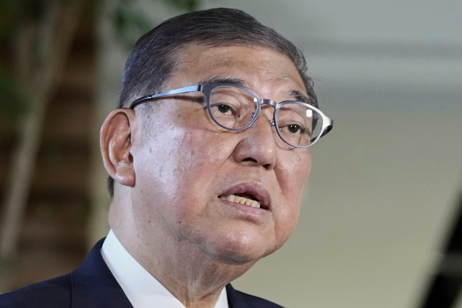 Japanese Prime Minister Shigeru Ishiba speaks to the media as President Donald Trump announced a trade framework with Japan, at the prime minister's office in Tokyo, Japan, Wednesday, July 23, 2025. (Kyodo News via AP)