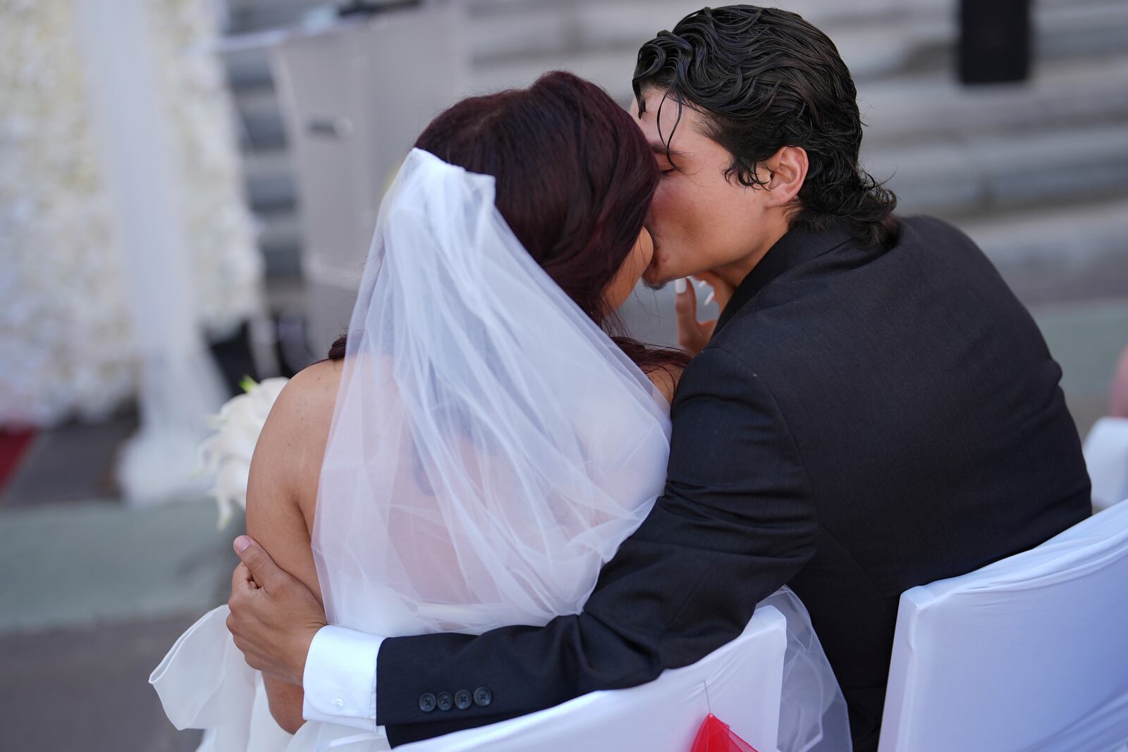 FILE - Newlyweds kiss after being wed in a Valentine's Day group wedding ceremony at the Dade County Courthouse in Miami, Friday, Feb. 14, 2025. (AP Photo/Rebecca Blackwell, File)
