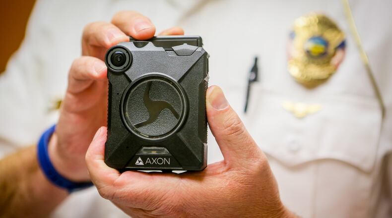 Sgt. Brian Robinson of the Hamilton Police Department displays an Axon body camera, one the cameras the department is currently testing. The Hamilton Police Department plans to have all frontline officers in body cameras by the end of 2017. GREG LYNCH / STAFF