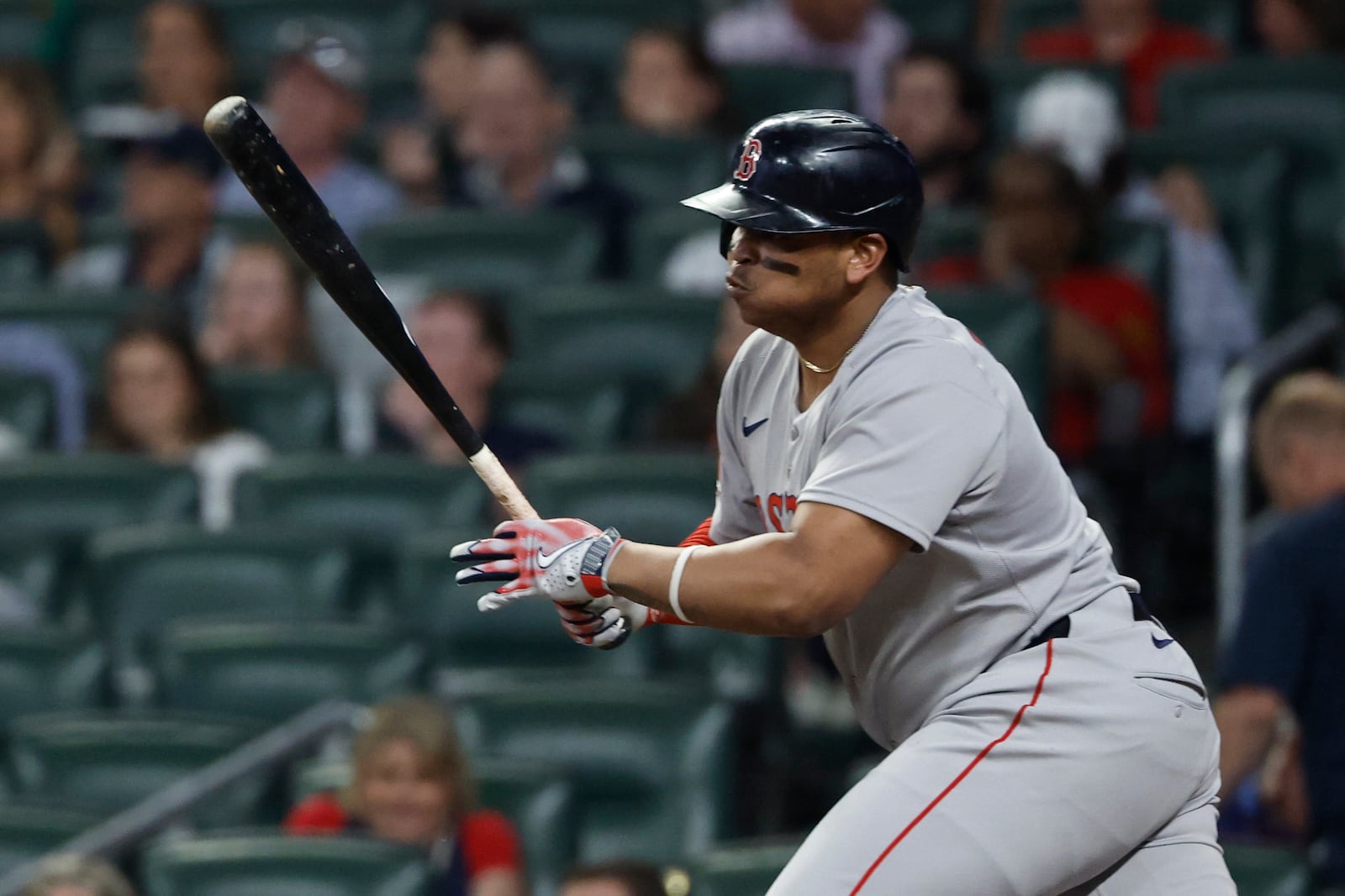 Boston Red Sox's Rafael Devers hits a two run RBI double during the ninth inning of a baseball game against the Atlanta Braves, Friday, May 30, 2025, in Atlanta. (AP Photo/Butch Dill)
