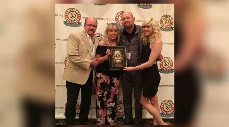 Professional wrestler and wrestling trainer Cody Hawk celebrated his Trainer’s Award in Las Vegas with his parents, to the left, Bo and Carol Myers of Kettering, and wrestler Shawna Reed, who he trains and is his girlfriend. PROVIDED
