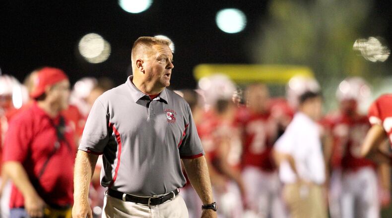 Lakota West coach Larry Cox paces the sideline during an Oct. 11, 2013, game against Fairfield at West. The host Firebirds won 35-3. FILE PHOTO