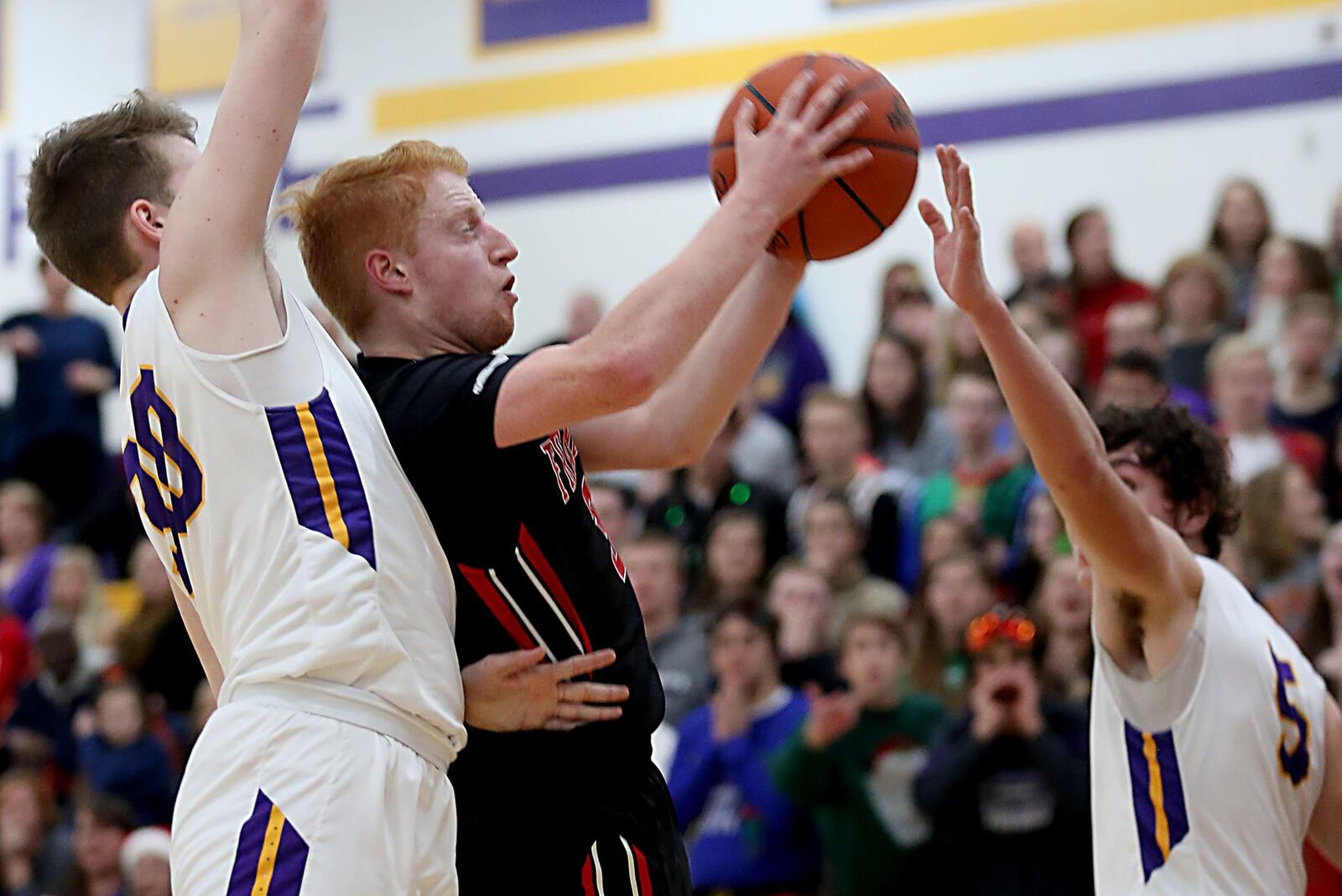 Franklin guard Will Kercher cuts between Bellbrook’s Caleb Scott (left) and Jack Campbell during Friday night’s game at Bellbrook. CONTRIBUTED PHOTO BY E.L. HUBBARD