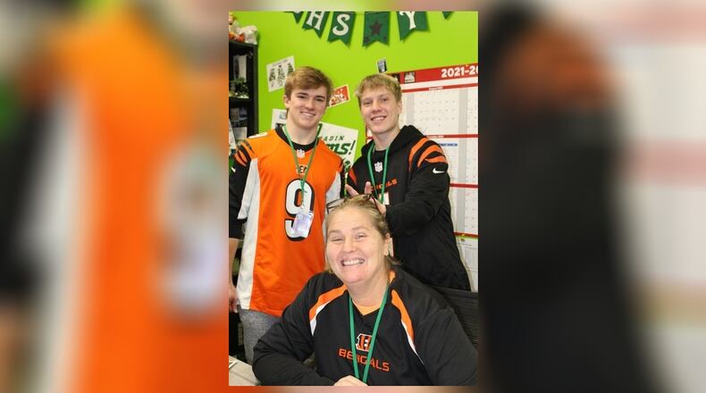 It will be the first Super Bowl for the Cincinnati Bengals in more than three decades but the day after will be a normal school day for most area schools, though some are giving their students and staffers the day off. Badin High School in Hamilton will be among those locally not holding classes. The school has been in a spirited, pro-Bengal mood with staffers and students sporting their Bengals' gear. Pictured are seniors Jack Walsh (left) and classmate Jackson Niesen in the Office of Campus Ministry with Director of Campus Ministry Gina Helms seated. CONTRIBUTED