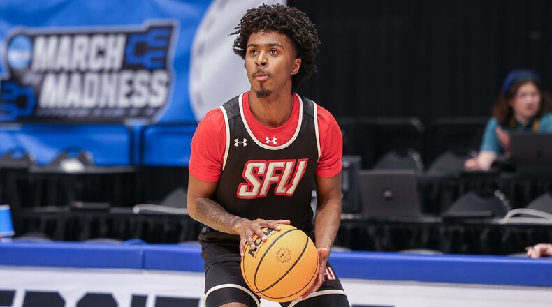 St. Francis University junior guard KJ Swain Jr. shoots a 3-pointer during a First Four practice on Monday at University of Dayton Arena. Swain is a Hamilton native. BRYANT BILLING / STAFF
