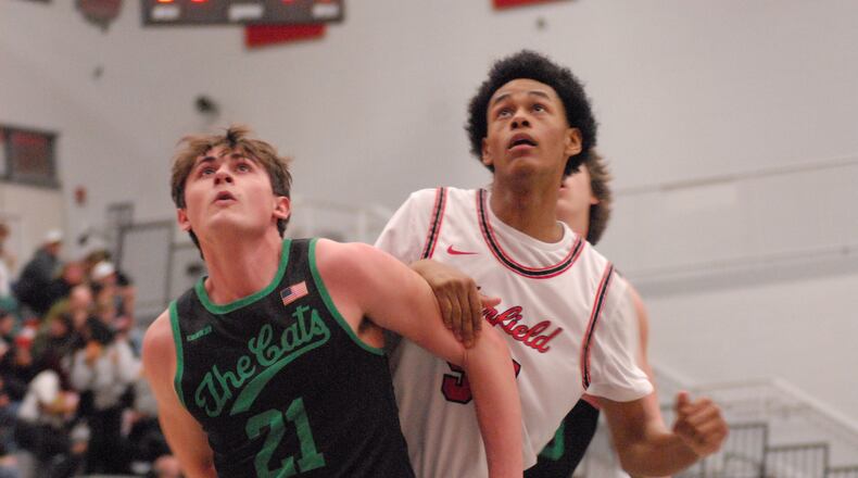 Harrison's Brody Mumfrey (21) boxes out Fairfield's Demaceo Bronston on Friday night. Chris Vogt/CONTRIBUTED