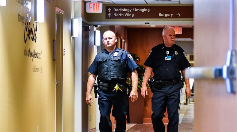 Kettering Health Network Police officers Kevin Gayhart, left, and Steve Rogers patrol Fort Hamilton Hospital Wednesday, August 7 in Hamilton. Kettering Health Network has their own police force across their network of hospitals. NICK GRAHAM/STAFF