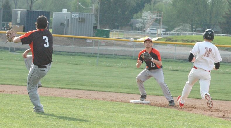 Waynesville second baseman Tanner Fannin (3) throws to shortstop Jonas Boggs (13) to get the out on Carlisle’s Nolan Burney at second base Monday during a Southwestern Buckeye League Buckeye Division baseball game at Sam Franks Field in Carlisle. Waynesville won 7-0. RICK CASSANO/STAFF
