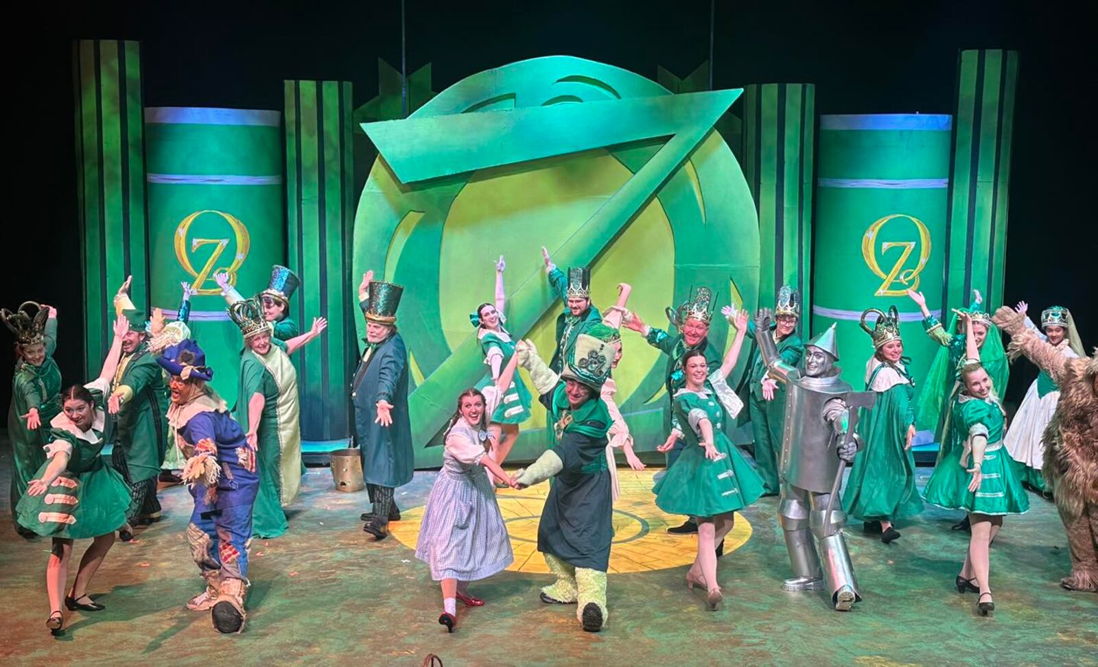 The cast of La Comedia Dinner Theatre's production of "The Wizard of Oz" performs "Merry Old Land of Oz." PHOTO BY JUSTIN WALTON
