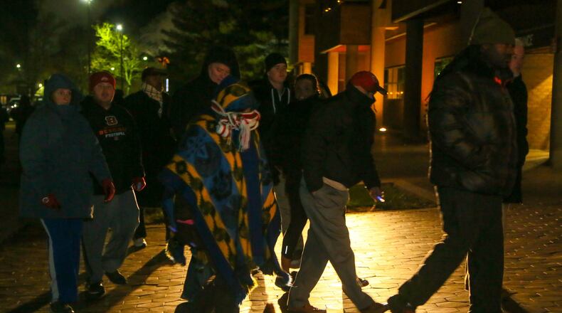 Local ministers and community members participated in a peace walk at the Middletown City Building, Friday, Dec. 9, to address a rash of shootings in the city. GREG LYNCH / STAFF Local ministers and community members participated in a peace walk at the Middletown City Building, Friday, Dec. 9, to address a rash of shootings in the city. GREG LYNCH / STAFF