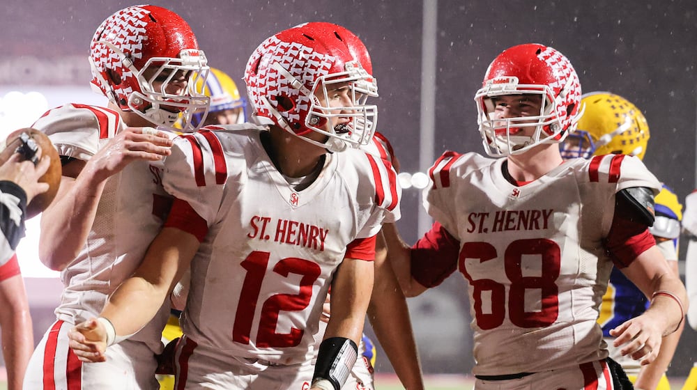 St. Henry senior quarterback Charlie Werling celebrates after a short touchdown run in the third quarter of the Division VII, Region 28 championship game on Friday, Nov. 21 at Mercy Health/Wapak VFW Field in Wapakoneta. Werling scored four TDs to help the Redskins win 24-7 and snap a 76-game winning streak by the Flyers. BRYANT BILLING/STAFF