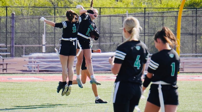 Badin High School's Bella (18) celebrates with teammate Claire Ressler (9) after scoring a touchdown against Mercy McAuley on Saturday at La Salle. Chris Vogt/CONTRIBUTED PHOTO
