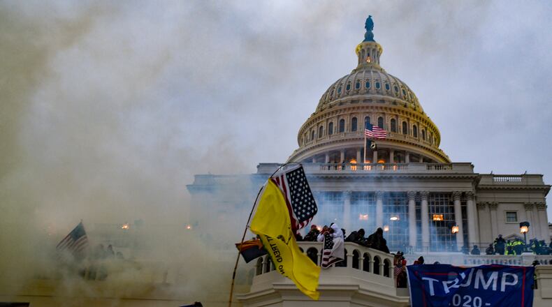 Authorities deploy tear gas as supporters of President Donald Trump swarm the Capitol in Washington on Wednesday, Jan. 6, 2021. (Kenny Holston/The New York Times)