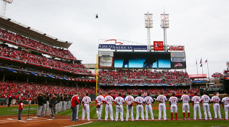 A helicopter flies over during the pre-game festivities of the Reds Opening Day game against the Pittsburgh Pirates at Great American Ballpark, Monday, Apr. 6, 2015. GREG LYNCH / STAFF