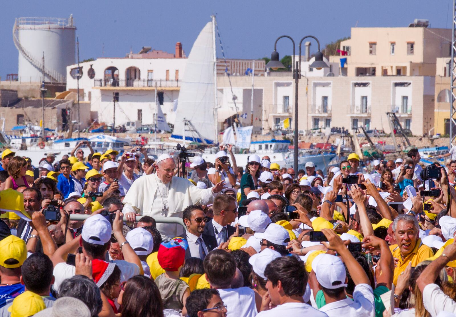 FILE - Pope Francis waves to a cheering crowd during his visit to the island of Lampedusa, Sicily, in southern Italy, July 8, 2013. (AP Photo/Alessandra Tarantino, File)